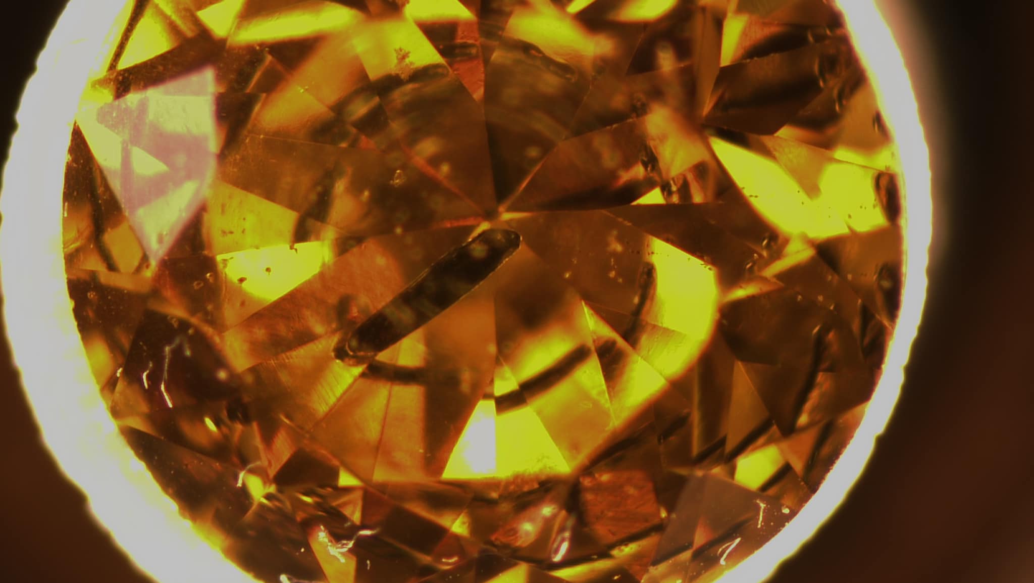 There are typical inclusions in this yellow HPHT-grown diamond.